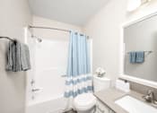 Thumbnail 20 of 25 - a bathroom with a shower toilet and sink