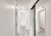 Thumbnail 6 of 24 - a bedroom with a large mirror and a hallway in the background