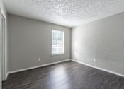 Thumbnail 46 of 46 - A room with a window and wooden flooring.
