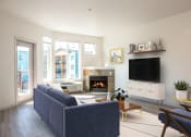 Thumbnail 6 of 42 - a living room with a couch and a tv and a fireplace