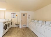Thumbnail 5 of 48 - A laundry room with washers and dryers.