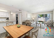 Thumbnail 1 of 2 - A well-lit apartment living room with a dining table and chairs.