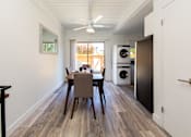 Thumbnail 22 of 29 - a dining area with a table and chairs and a washer and dryer