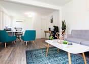 Thumbnail 20 of 29 - a living room with a couch coffee table and two chairs