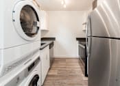 Thumbnail 19 of 29 - a washer and dryer in a laundry room