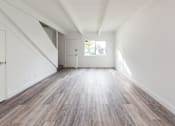 Thumbnail 10 of 29 - a bedroom with hardwood floors and white walls