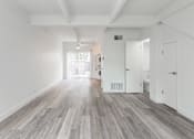 Thumbnail 9 of 29 - a bedroom with hardwood floors and white walls