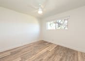 Thumbnail 5 of 29 - an empty room with a ceiling fan and a window
