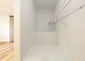 Thumbnail 6 of 29 - a room with a white floor and white walls and a white rack on the wall