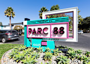 Thumbnail 1 of 29 - a sign in front of a parking lot