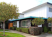 Thumbnail 3 of 29 - a building with a blue awning in front of it