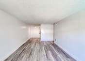 Thumbnail 5 of 24 - a spacious living room with hardwood floors and white walls