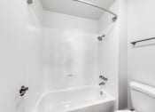 Thumbnail 11 of 24 - a bathroom with a toilet and a bathtub