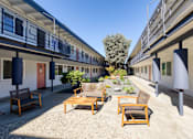 Thumbnail 23 of 24 - a courtyard with chairs and tables on a sunny day