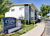 Thumbnail 3 of 17 - a building with a sign that says the carolina apartments