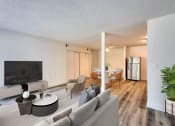 Thumbnail 3 of 15 - a living room with white walls and hardwood floors