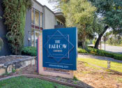Thumbnail 1 of 15 - a blue and pink sign in front of a building