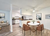 Thumbnail 5 of 15 - a dining area with a table and four chairs and a kitchen in the background