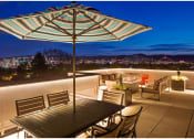 Thumbnail 17 of 23 - a terrace with a table and chairs under an umbrella