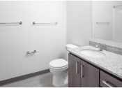 Thumbnail 9 of 23 - a bathroom with a toilet sink and mirror