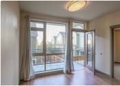 Thumbnail 10 of 23 - a living room with sliding glass doors and a balcony