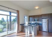 Thumbnail 4 of 23 - a kitchen with a large sliding glass door leading to a balcony
