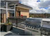 Thumbnail 16 of 23 - a stainless steel barbecue on the patio of a home