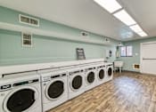 Thumbnail 28 of 31 - a washer and dryer in a room with a wood floor