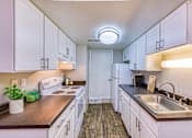 Thumbnail 18 of 31 - the preserve at ballantyne commons apartment kitchen with white cabinets