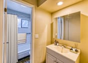 Thumbnail 22 of 31 - a bathroom with a sink and a shower and a mirror