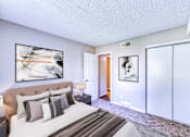 Thumbnail 20 of 31 - a bedroom with a large bed and sliding glass doors