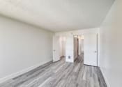Thumbnail 19 of 24 - a bedroom with hardwood floors and white walls