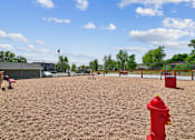 Thumbnail 4 of 22 - A red fire hydrant sits in the middle of a playground.