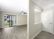 Thumbnail 13 of 22 - a bedroom with a door to a patio and a ceiling fan