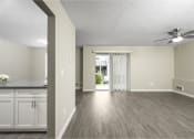 Thumbnail 8 of 22 - a living room and dining room with a ceiling fan
