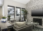 Thumbnail 6 of 22 - a living room with a fireplace and a tv on the wall