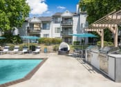 Thumbnail 19 of 22 - the reserve at bucklin hill pool and grilling area with lounge chairs and umbrellas