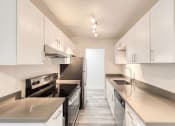 Thumbnail 1 of 24 - a kitchen with white cabinets and stainless steel appliances