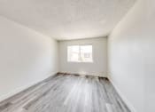 Thumbnail 14 of 24 - a bedroom with hardwood floors and white walls