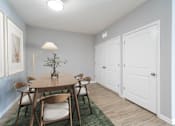 Thumbnail 4 of 15 - A dining room with a wooden table and chairs.