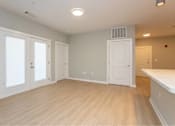 Thumbnail 13 of 24 - A room with white doors and a window, and a white counter.