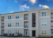 Thumbnail 2 of 24 - Apartment building with balconies and multiple windows.