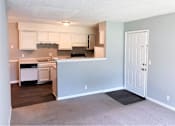 Thumbnail 9 of 24 - A kitchen with white cabinets and a black stove top oven.