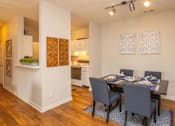 Thumbnail 8 of 27 - A dining room with a table set for four.