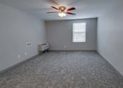 Thumbnail 3 of 31 - A room with a ceiling fan and a window with blinds.