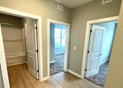 Thumbnail 26 of 38 - A room with a white door and a window.