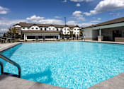 Thumbnail 36 of 38 - A large swimming pool in front of a building.