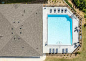 Thumbnail 37 of 38 - An aerial view of a building with a pool.