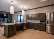 Thumbnail 3 of 38 - A kitchen with dark brown cabinets and stainless steel appliances.