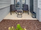 Thumbnail 12 of 15 - A small patio with a table and two chairs.